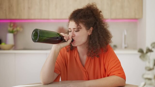 Unhappy young woman crying and drinking wine alone, relationship problems