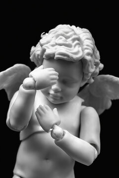 Sad cherub with facepalm gesturing. Angel figurine holding his head in hands