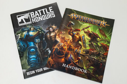 Bradford, UK Sep 26 2025 - The warhammer battle honours book, and the Age Of Sigmar handbook shot together over a white background.