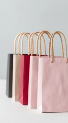 A neat row of pastel-colored shopping bags with rope handles arranged against a light background. The clean, minimalistic design highlights retail, packaging, and consumer lifestyle concepts