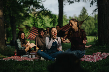A cheerful group of friends having a picnic with food and laughter, relaxing outdoors.