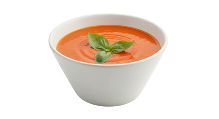 Isolated Tomato soup in white bowl topped with basil leaves, healthy gourmet meal