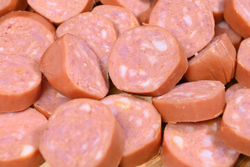 closeup of cut raw pepperoni sausages