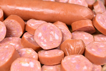 closeup of cut raw pepperoni sausages