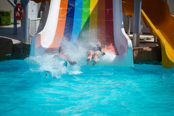

A person splashes into a bright turquoise pool at Soma Bay, Hurghada, Egypt, after sliding down...