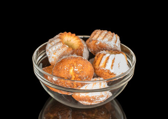 Sweet homemade cupcakes isolated on black background, close-up.
