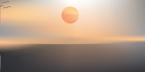 Out of focus sun setting over the ocean glowing orange with dark blue background