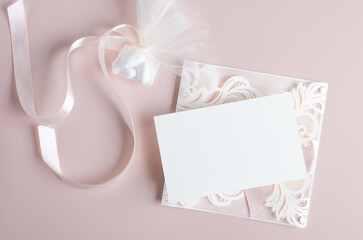 White wedding luxury invitation card mockup 7x5 on pastel pink background with envelop and fabric. Baby shower o bridal shower mockup. Minimal style blank mockup, thank you card, greeting card