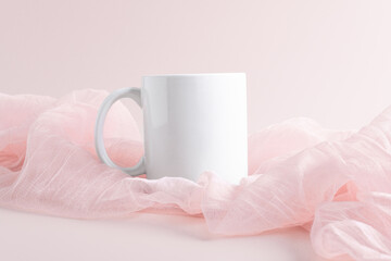 White mug mockup on a pink fabric on pasel pink background, copy space. Blank template for your design, branding, business