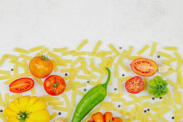 Raw mafalda corta pasta with assorted heirloom tomatoes, garlic, chili pepper, and spices