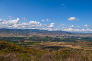 Fototapeta premium Amazing landmark with settlements and mountains and cloudy sky at Armenia-Georgia state border