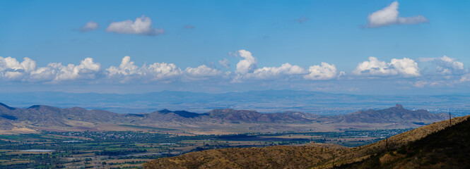 Amazing landmark with settlements and mountains and cloudy sky at Armenia-Georgia state border