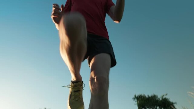 Runner jumping over the camera, motivational dynamic hero shot in slow motion