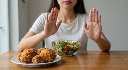 A person chooses healthy eating by rejecting fried chicken in favor of a fresh salad.