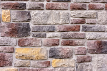 Textured stone wall with a variety of colors and patterns