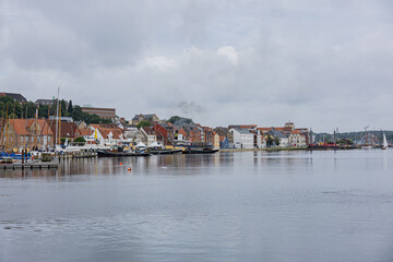 Panoramic view of Flensburg harbor with historic waterfront houses and boats on calm water