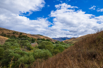 Scenic landmark with forest and blu cloudy sky, Armenia