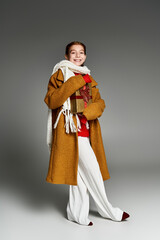 Fototapeta premium Charming preteen girl showcases trendy winter fashion in stylish studio setting