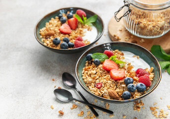 Granola bowls with yogurt, berries, and mint for breakfast