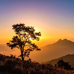Silhouette of a lone tree against a vibrant mountain sunset sky.