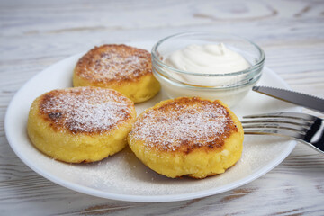 Cheesecakes with sour cream on a white plate