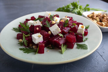 Delicious bright salad with beetroot, arugula, and feta on a light background