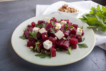 Delicious bright salad with beetroot, arugula, and feta on a light background