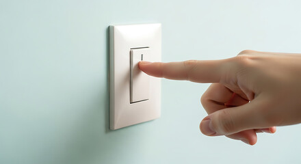 Hand flipping a light switch, activating electrical power, illuminating a space, and controlling a device