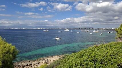 Scenic coastal view with boats anchored in clear blue water  