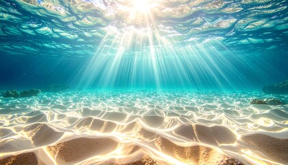 Underwater view shows sunbeams filtering through turquoise water onto a sandy floor