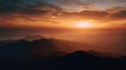 Obraz premium Majestic mountain range bathed in the warm golden light of a dramatic sunrise