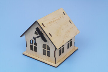 Military drone hits house on blue background. Concept of drones attack houses.