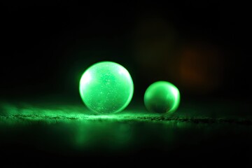 Two glowing green spheres on a dark surface