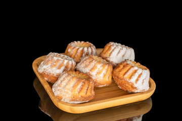 Sweet homemade cupcakes isolated on black background, close-up.