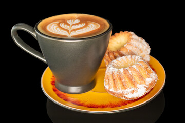 Sweet homemade cupcakes isolated on black background, close-up.