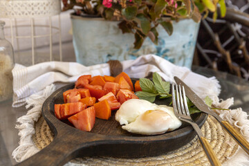 Rustic Breakfast Platter with poached eggs, fresh greens and vegetables on a textured woven mat. Cozy, homey dining vibe.
