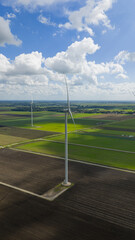 Wind turbines, clean energy and renewable energy. Beautifull crips blue sky and white clouds.