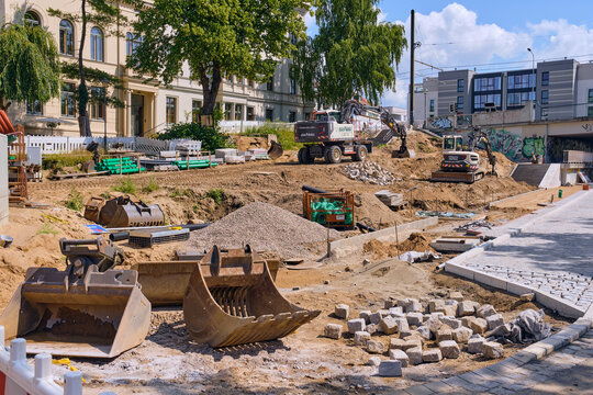 Large-scale urban paving and road reconstruction in Rostock city center with Volvo mini excavator and ASA BAU wheeled excavator, cobblestone installation and civil engineering works in Germany