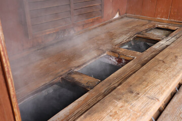 Traditional Japanese Onsen Hot Spring with Rising Steam at Aso