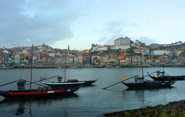 Porto, traditional boats on the river Douro with view to the old town center