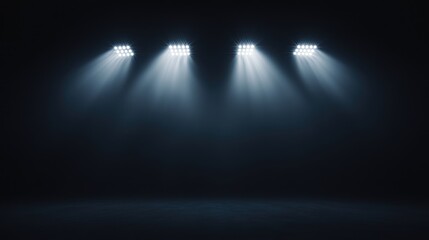 Four spotlight beams on dark background