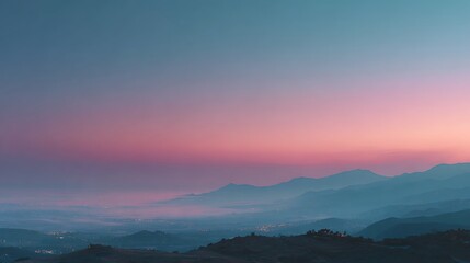 Stunning Sunset Over Rolling Mountains with Colorful Gradient Sky and Urban Lights in Dusk