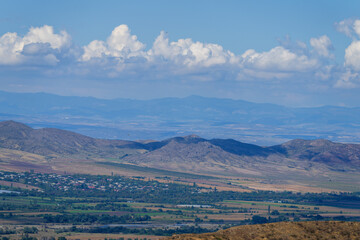 Fototapeta premium Amazing landmark with settlements and mountains and cloudy sky at Armenia-Georgia state border