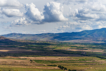 Obraz premium Amazing landmark with settlements and mountains and cloudy sky at Armenia-Georgia state border