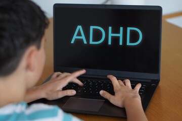children, adolescents, and ADHD. Preteen boy typing the concept on his laptop.