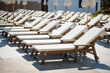 The sun loungers at the hotel are soft and comfortable and arranged in order.