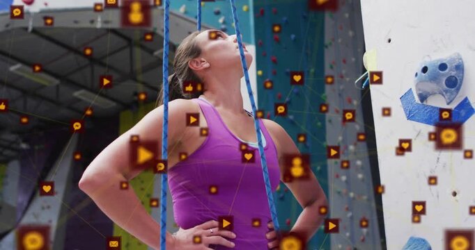 Belayer gripping rope as social icons drifting feeding slack via belay device supporting climber