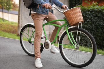 Naklejka premium Man riding bicycle on city street, closeup