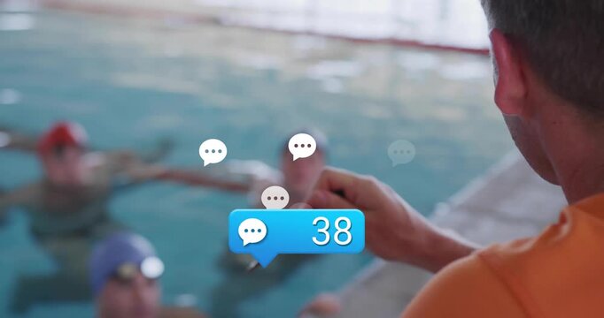 swim coach tapping smartphone monitoring chat bubbles counting up to ninety five as swimmers wait