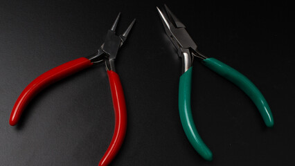 Precision tools for crafting and jewelry making arranged on a black surface